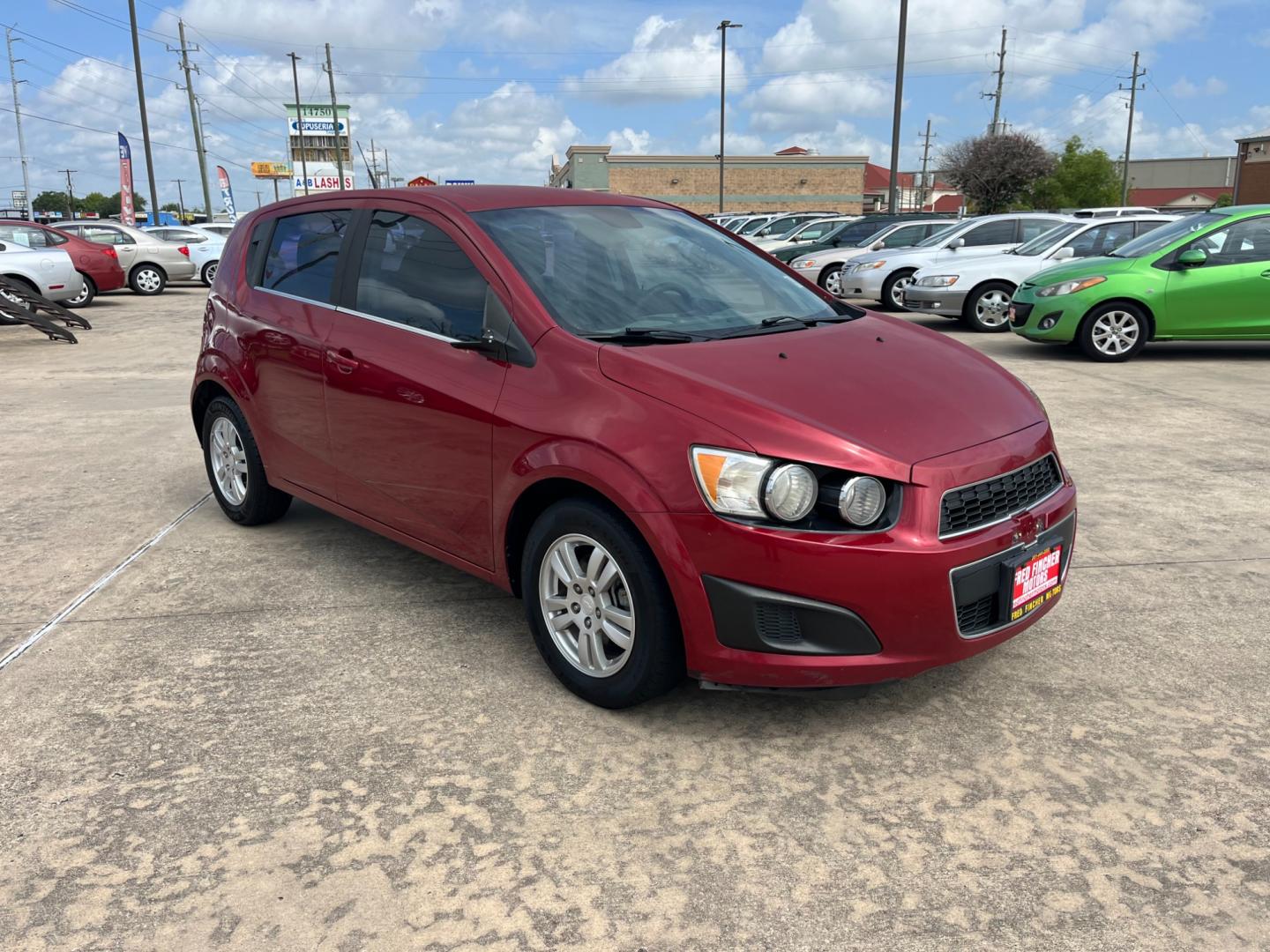 2013 red /black Chevrolet Sonic LT Auto 5-Door (1G1JC6SH3D4) with an 1.8L L4 DOHC 24V FFV engine, 6-Speed Automatic transmission, located at 14700 Tomball Parkway 249, Houston, TX, 77086, (281) 444-2200, 29.928619, -95.504074 - Photo#0